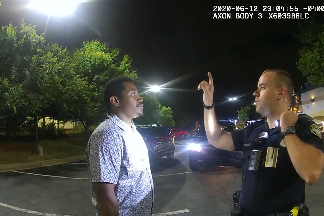 Former Atlanta Police Department officer Garrett Rolfe conducts sobriety test on Rayshard Brooks in a Wendy's restaurant parking lot