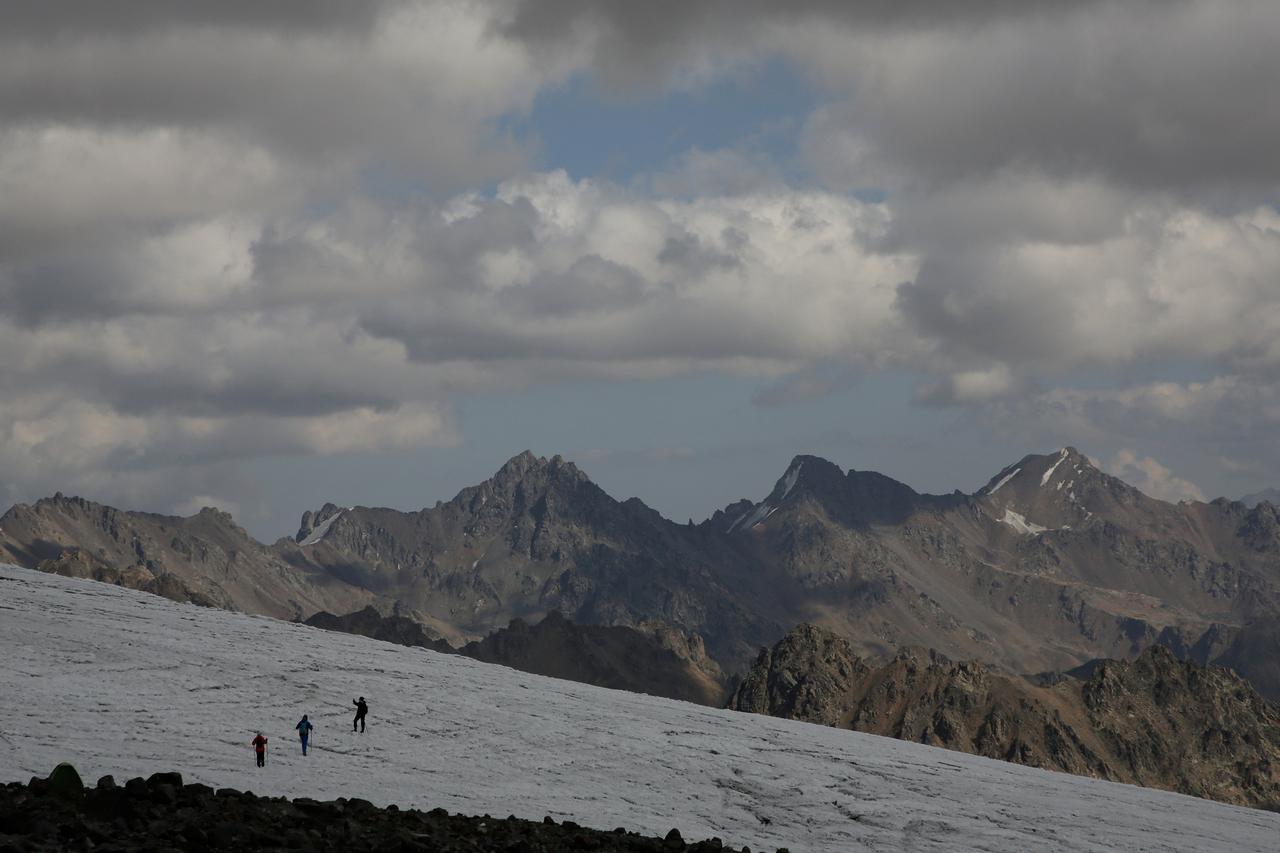 FILE PHOTO: People walk on the slope of Mount Elbrus in the Republic of Kabardino-Balkaria