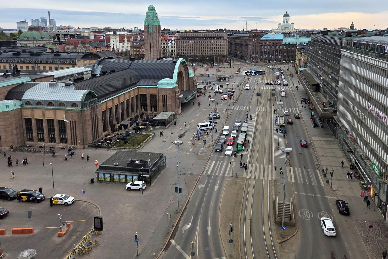 Cars drive past Central station in Helsinki