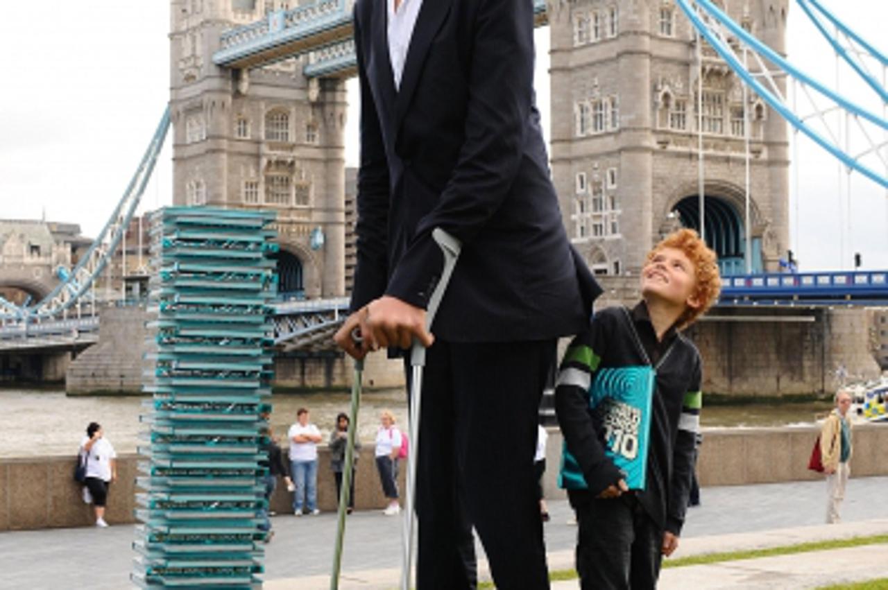 \'Sultan Kosen, from Turkey, stands next to Josh Henderson, from West Horsley, as he is announced as the Guinness World Records Tallest Man standing at 8ft 1, seen in Potters Field in London. Photo: P
