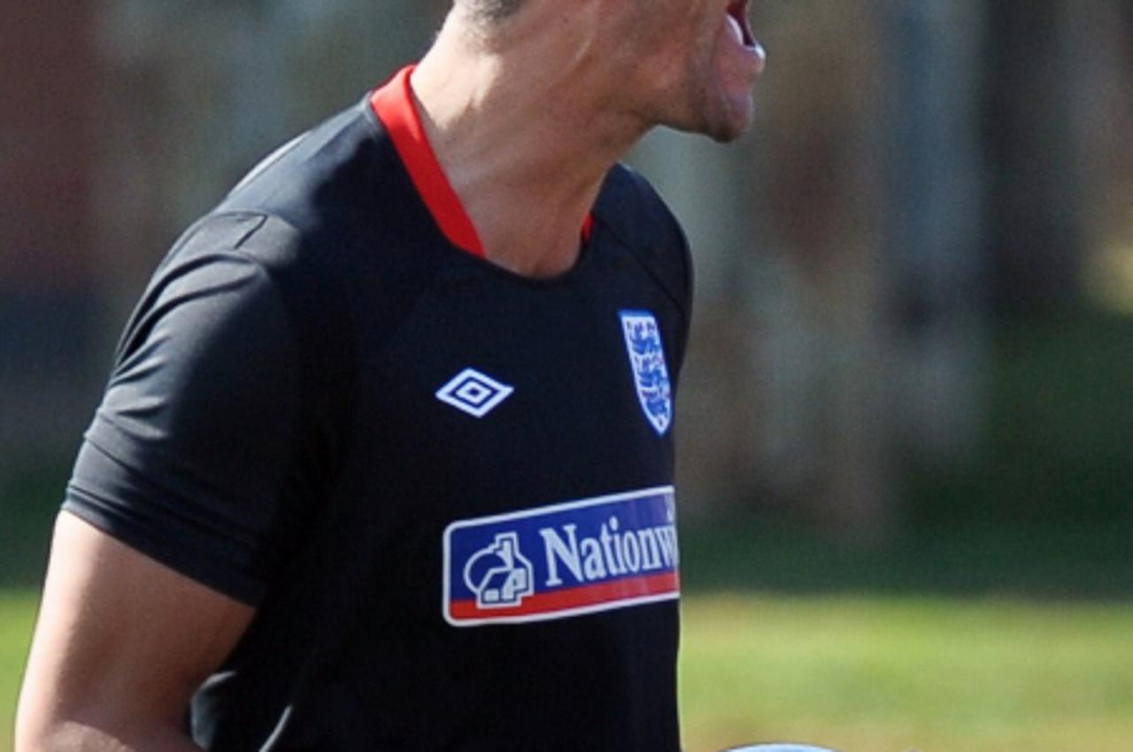 \'England\'s Rio Ferdinand laughs during a training session at the Royal Bafokeng Sports Campus near Rustenburg on June 4, 2010, ahead of their opening game against USA on June 12. England skipper Rio