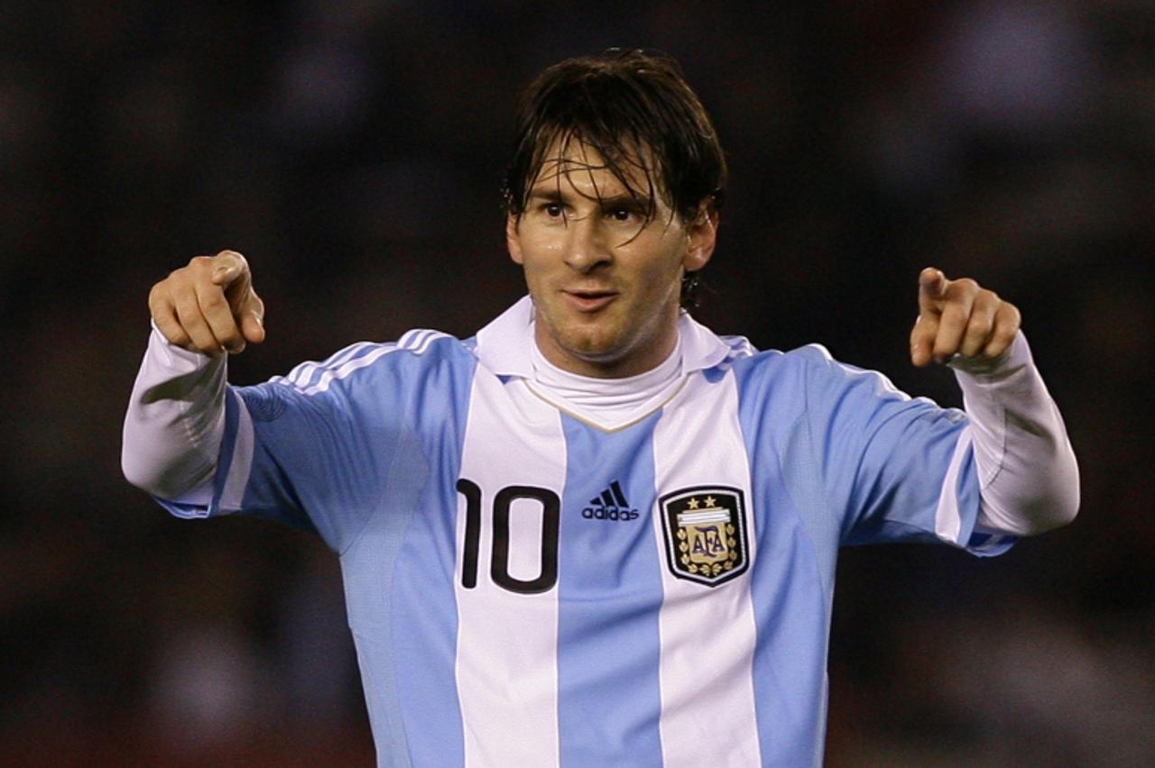 'Argentina\'s forward Lionel Messi celebrates after scoring team\'s second goal against Albania during a friendly football match at the Monumental stadium in Buenos Aires on June 20, 2011. AFP PHOTO /