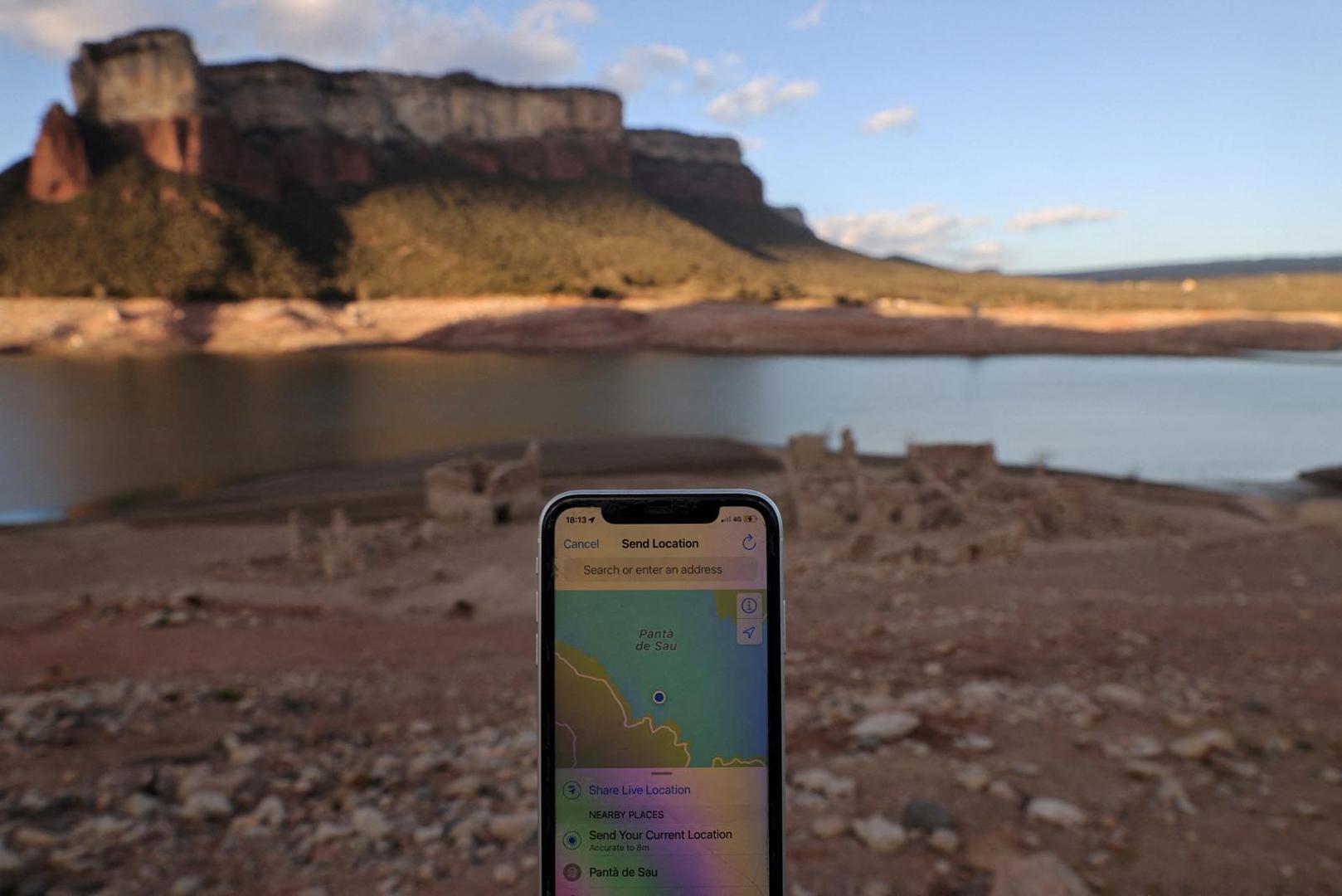 The location of a mobile is pictured in front of the village of San Roman de Sau which was partially submerged and re-emerged as Sau reservoir has the lowest level since 1990 due to extreme drought in Catalonia, near Vic, Spain March 14, 2023. REUTERS/Nacho Doce Photo: NACHO DOCE/REUTERS