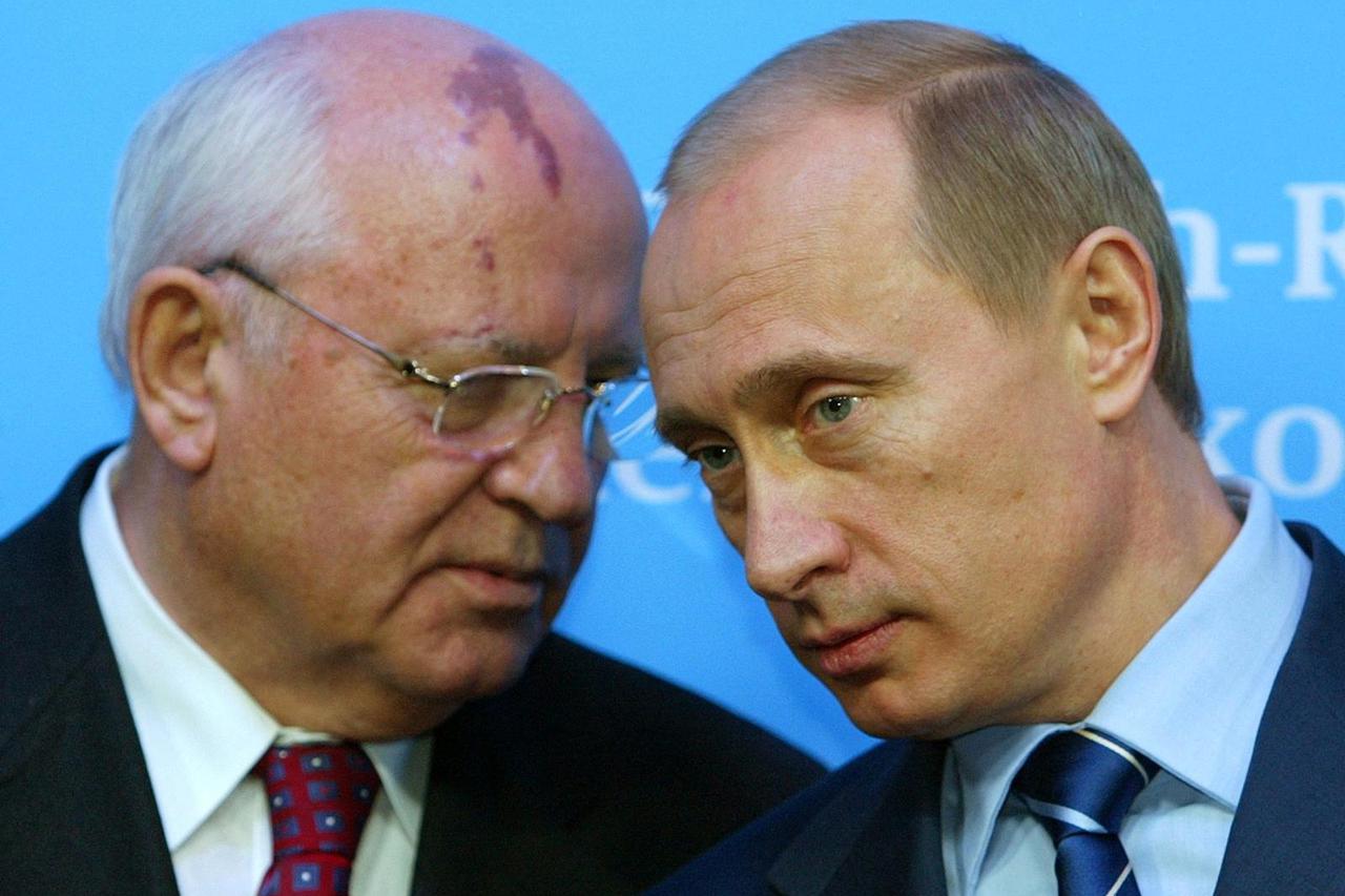 FILE PHOTO: Russian President Putin listens to former President of the Soviet Union Gorbachev during news conference in Schleswig