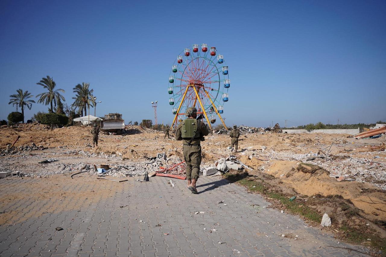 Israeli soldiers walk during an operation as they continue their ground offensive in Gaza