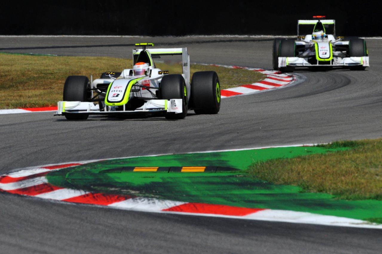 'Brawn GP\'s Brazilian driver Rubens Barrichello drives ahead of Brawn GP\'s British driver Jenson Button at the Autodromo Nazionale circuit on September 13, 2009 in Monza, during the Formula One Ital