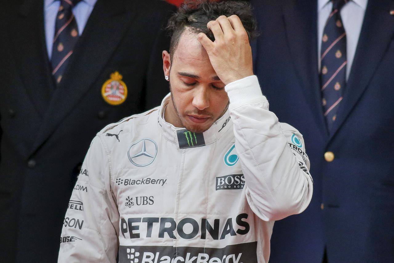 Mercedes Formula One driver Lewis Hamilton of Britain reacts on the podium after placing third in the Monaco Grand Prix in Monaco May 24, 2015. REUTERS/Robert Pratta