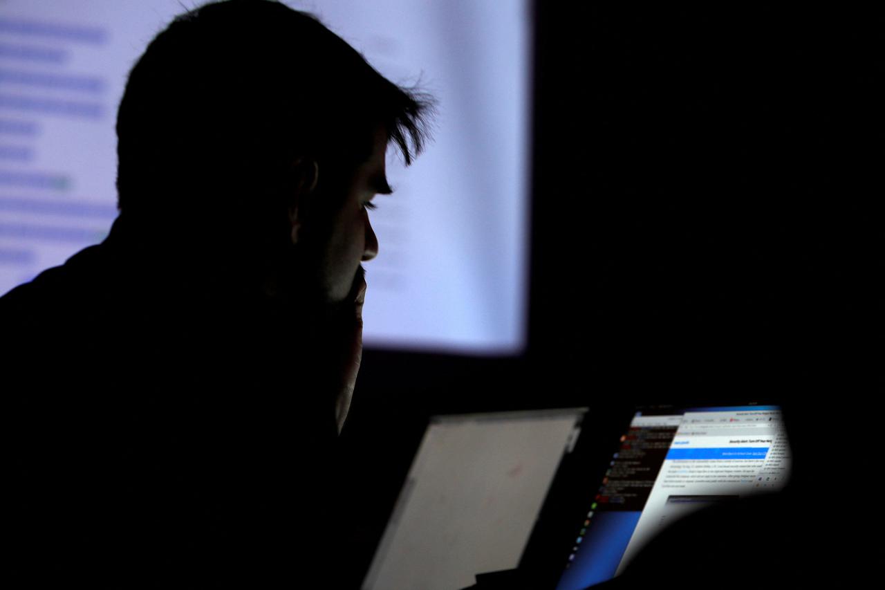 FILE PHOTO: A man takes part in a hacking contest during the Def Con hacker convention in Las Vegas