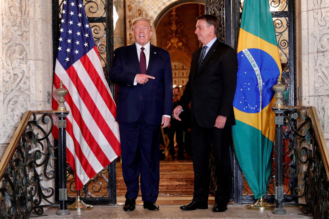 FILE PHOTO: U.S. President Donald Trump participates in a working dinner with then-Brazilian President Jair Bolsonaro at the Mar-a-Lago resort in Palm Beach, Florida