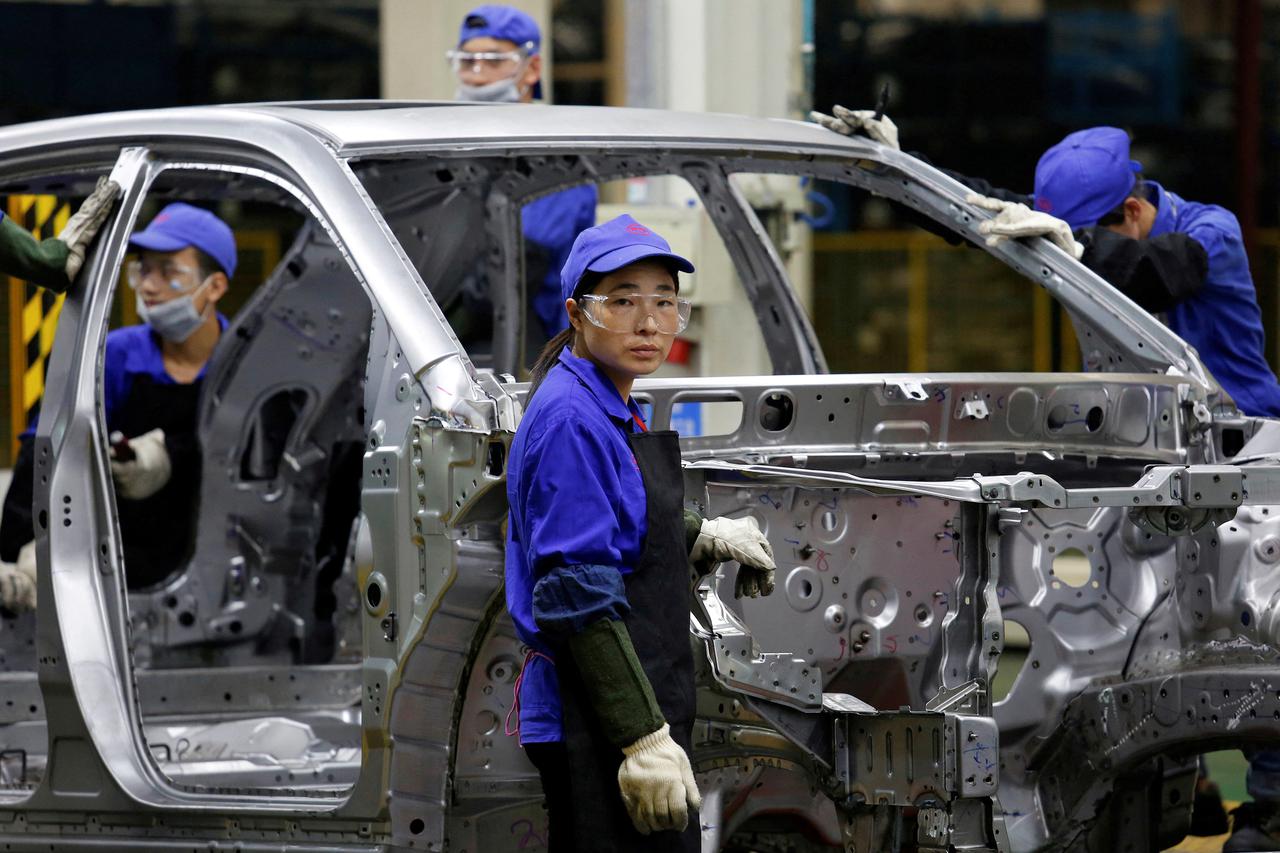 FILE PHOTO: A worker looks at a BYD assembly line in Shenzhen