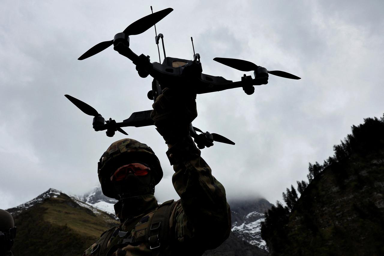 A Swiss army drone operator controls a first person view drone during a presentation of usage of small drones at an army facility in Elm