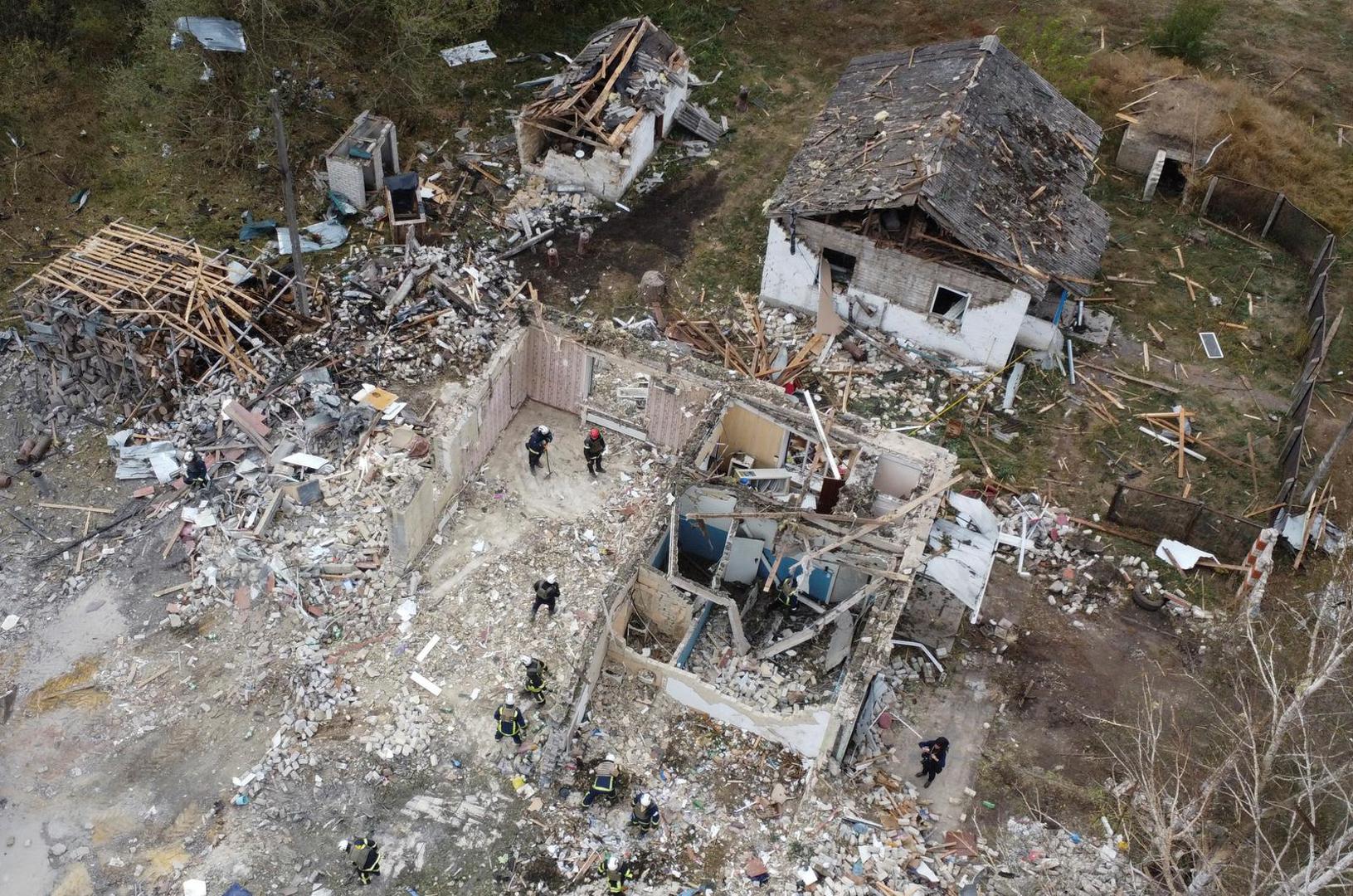 Rescues remove debris at a site of buildings of a local cafe and a grocery store, where at least 52 people were killed by a Russian missile strike, amid Russia's attack on Ukraine, in the village of Hroza, in Kharkiv region, Ukraine October 6, 2023. REUTERS/Yan Dobronosov Photo: STRINGER/REUTERS