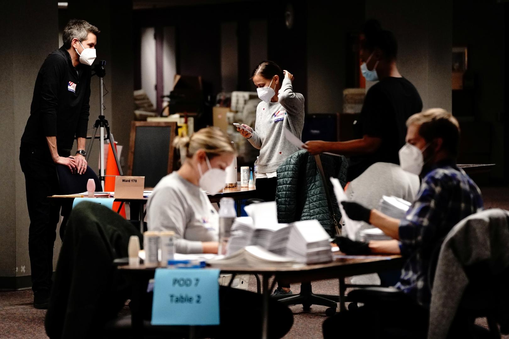 2020 U.S. presidential election in Wisconsin Poll workers process absentee ballots the night of Election Day at Milwaukee Central Count in Milwaukee, Wisconsin, U.S. November 3, 2020. REUTERS/Bing Guan BING GUAN