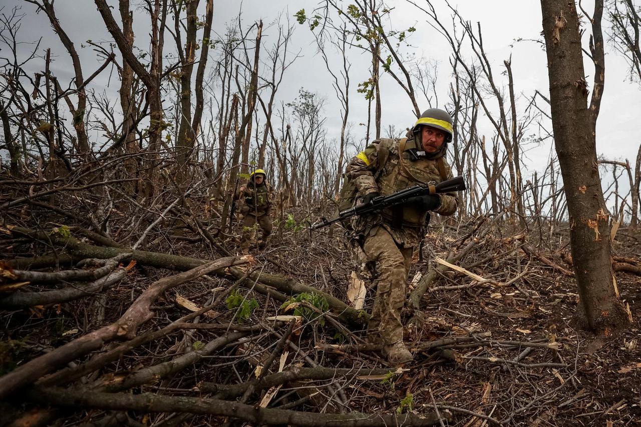 FILE PHOTO: Ukrainian servicemen check Russian positions after a fight near the front line city of Bakhmut