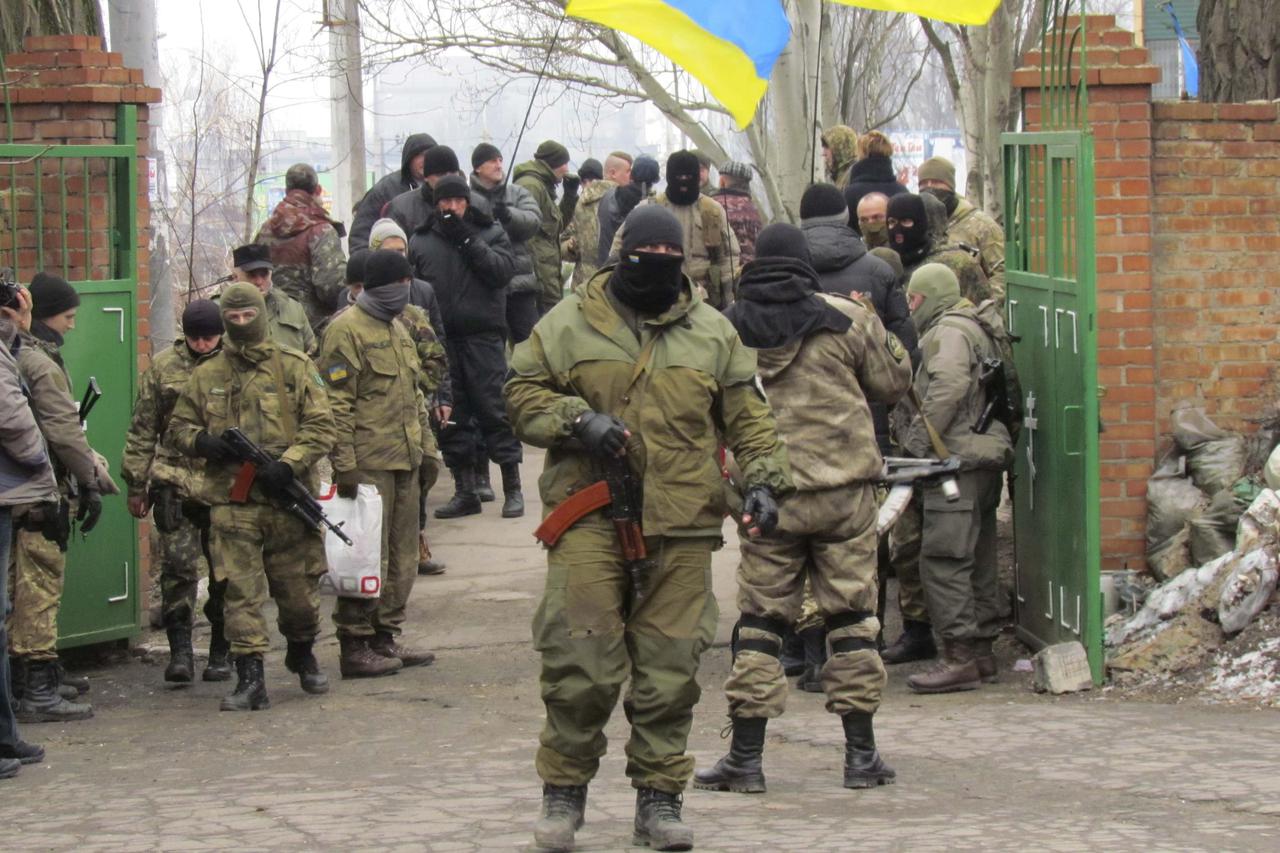 Members of the armed forces of Ukraine attend the funeral of a Ukrainian serviceman, who was killed while taking part in battles at the airport of Donetsk, in Mariupol, a city on the Sea of Azov, January 27, 2015. European Union leaders asked their foreig