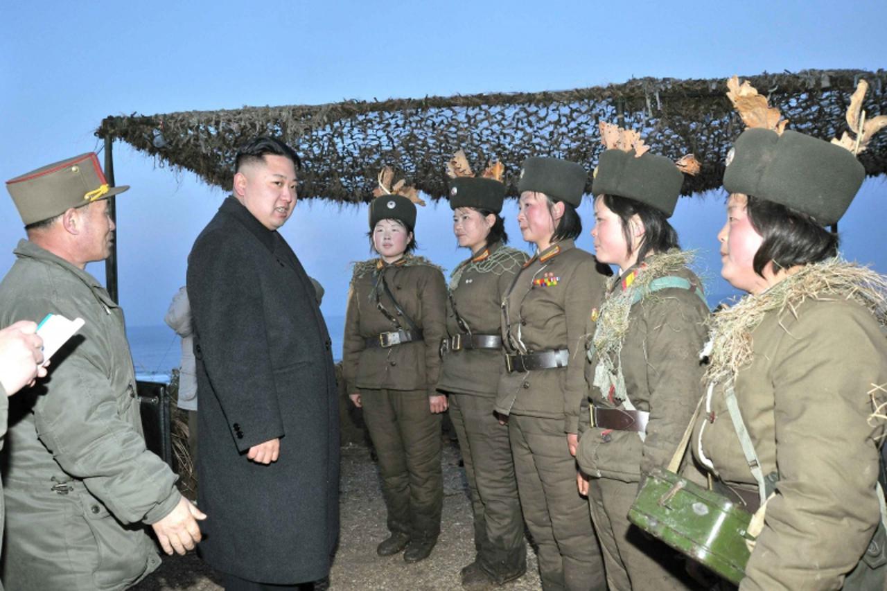 'North Korean leader Kim Jong-Un (2nd L) talks with soldiers of the Korean People\'s Army (KPA) taking part in the landing and anti-landing drills of KPA Large Combined Units 324 and 287 and KPA Navy 