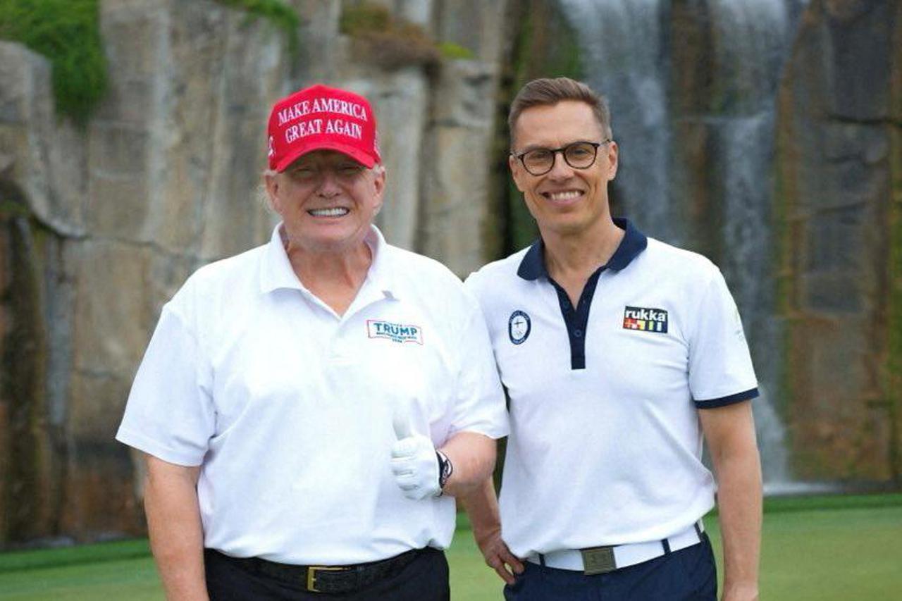 U.S. President Donald Trump gestures as Finland's President Alexander Stubb stands next to him in Palm Beach