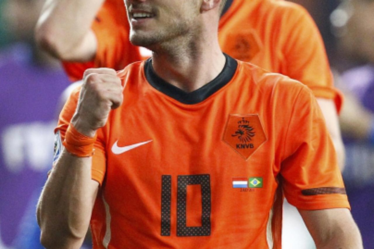 'Netherlands\' Wesley Sneijder celebrates victory over Brazil after their 2010 World Cup quarter-final soccer match in Port Elizabeth July 2, 2010.              REUTERS/Jerry Lampen (SOUTH AFRICA  - T