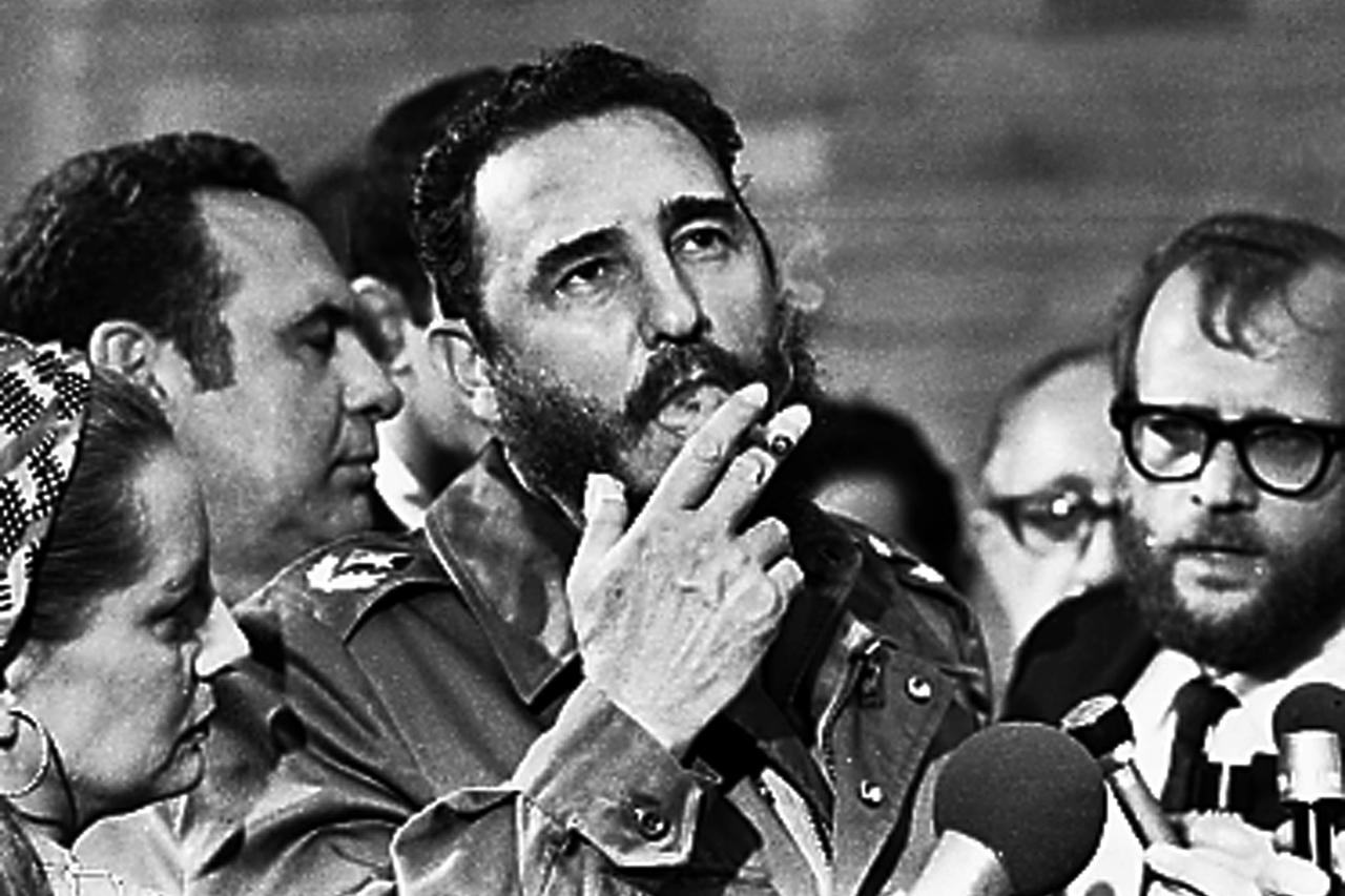 Then Cuban Prime Minister Fidel Castro smokes a cigar during interviews with the press during a visit of U.S. Senator Charles McGovern, in Havana in this May 1975 file photo. REUTERS/Prensa Latina/File Photo