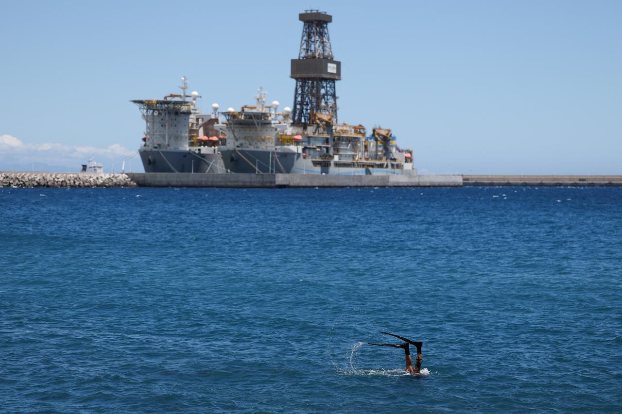 A person dives near the Granadilla port, where the cruise ship MV Hondius, is expected to arrive within three days, following a deadly hantavirus outbreak, at the port of Granadilla de Abona