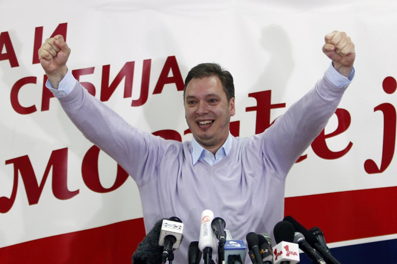 'Serbian Progressive Party deputy president Aleksandar Vucic celebrates party leader and presidential candidate Tomislav Nikolic\'s victory in Belgrade May 20, 2012. Opposition leader Tomislav Nikolic