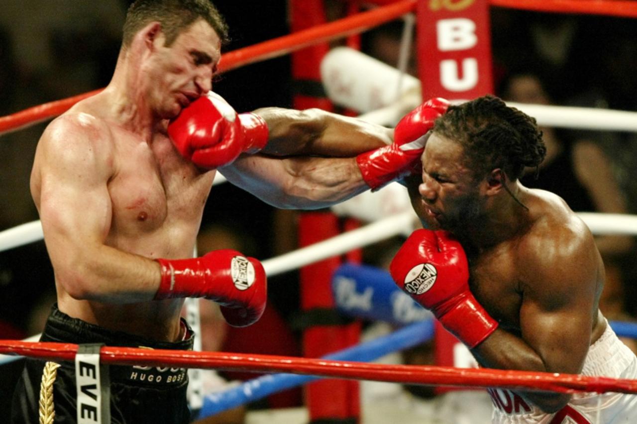 \'Vitali Klitschko (L) of Ukraine takes a hit from WBC heavyweight champion Lennox Lewis from Britain during their title fight at the Staples Center in Los Angeles, June 21, 2003. The fight was stoppe