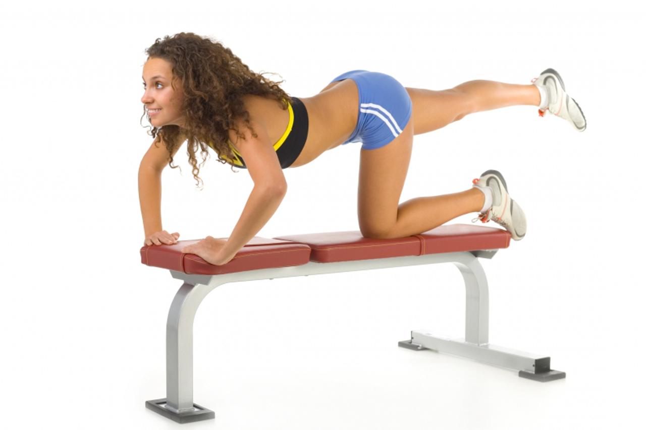 'Woman stretching on bench'