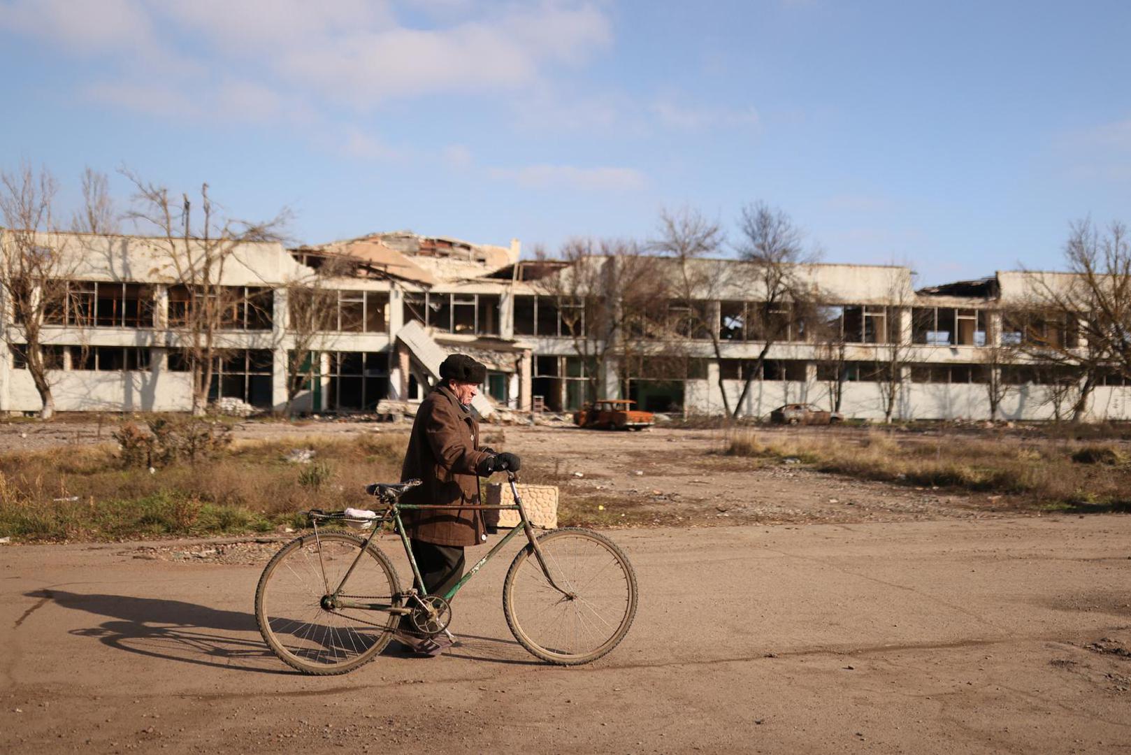 Volodymyr Kovalyov, 77, who remained in his village throughout the conflict and was in his house in October when it was hit by what he thinks was a tank shell, walks with his bicycle to a food delivery point, amid Russia's invasion of Ukraine, in the village of Posad-Pokrovske, northwest of the city of Kherson, Ukraine January 26, 2023. Russian troops reached Posad-Pokrovske on Feb. 25 last year, the day after Russia launched the full-scale invasion it calls a "special military operation" in Ukraine. It was as far as they were able to push north, and the area around the small settlement became a no-go zone between enemy forces. The ground is now littered with ammunition boxes, bullet casings and burned out Russian tanks. Mines lay scattered, two unexploded missiles protrude from the earth nearby, deep, narrow trenches snake through fields and house after house lays in ruins.      REUTERS/Nacho Doce           SEARCH "DOCE UKRAINE VILLAGE" FOR THIS STORY. SEARCH "WIDER IMAGE" FOR ALL STORIES.      TPX IMAGES OF THE DAY Photo: NACHO DOCE/REUTERS
