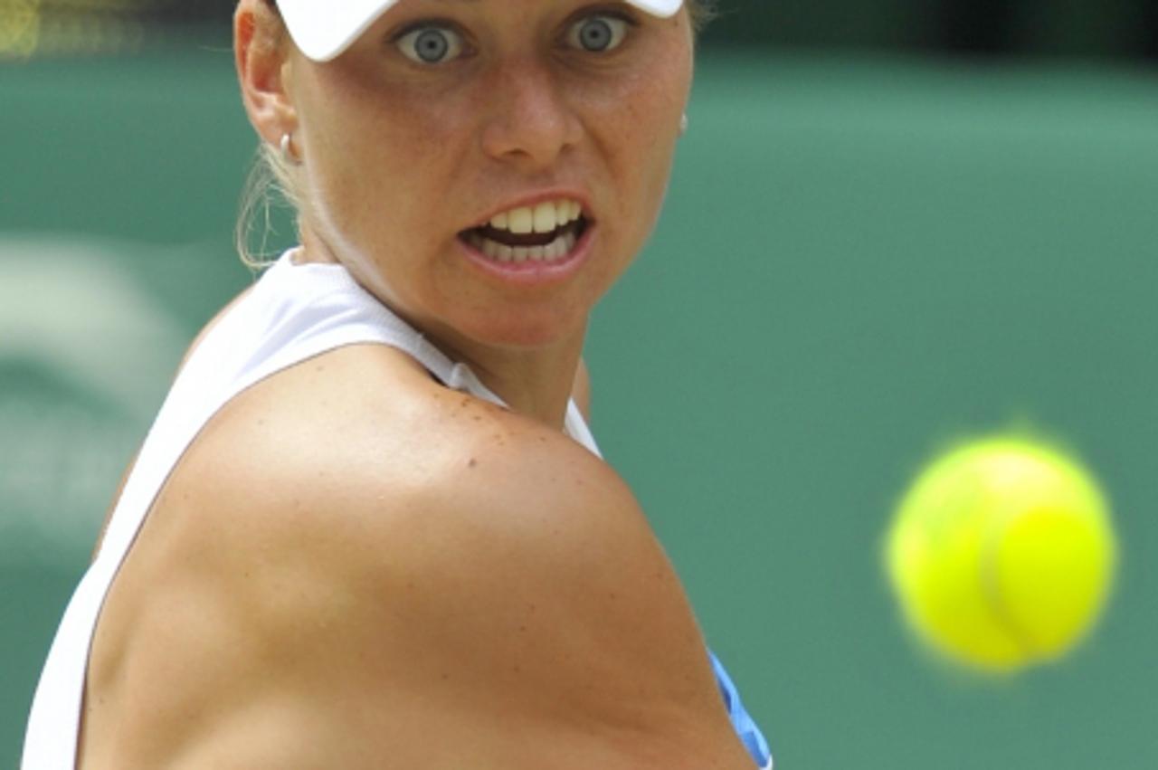 'Russia\'s Vera Zvonareva hits a return to Bulgaria\'s Tsvetana Pirinkova during their women\'s semi-final match at the 2010 Wimbledon tennis championships in London, July 1, 2010.      REUTERS/Toby M