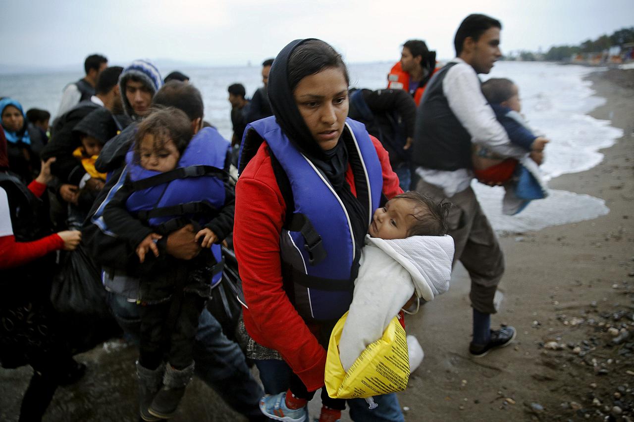 Afghan immigrants land at a beach on the Greek island of Kos after crossing a portion of the south-eastern Aegean Sea between Turkey and Greece on a dinghy early May 27, 2015. Despite the bad weather at least a dingy with over thirty migrants made the dan
