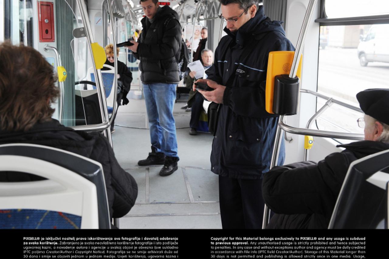 '10.01.2013., Zagreb -  Reportaza o kontrolorima ZET-a. Kontrolori Zeljko Marinovic i Davor Guja pregledavali su karte putnika u tramvajima.  Photo: Davor Visnjic/PIXSELL'