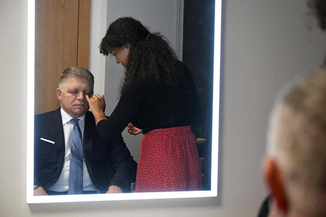 Robert Fico, leader of the SMER-SSD party, is sited in front of a mirror as he gets his make up applied by a make up artist before a televised debate at TV TA3, in Bratislava