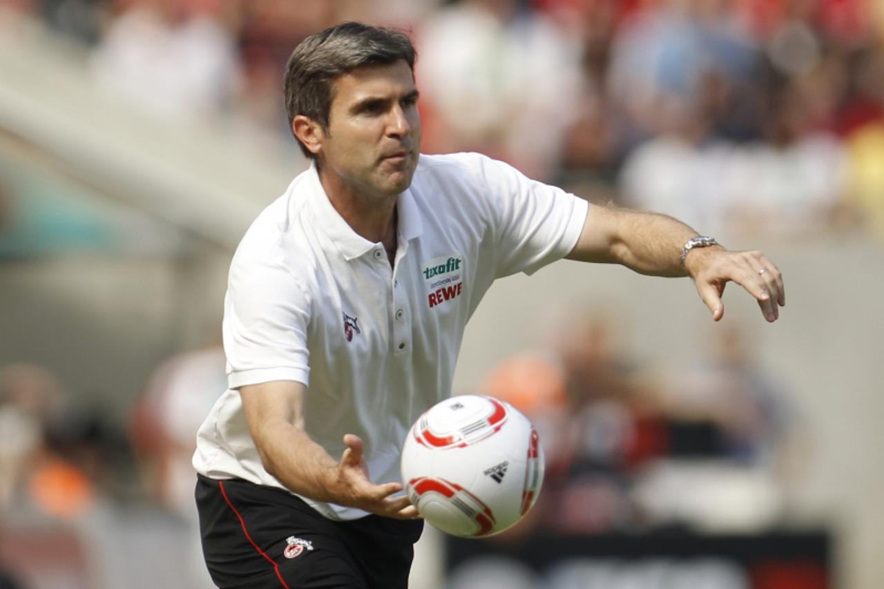 \'Cologne\'s coach Zvonimir Soldo catches a ball during the German Bundesliga soccer match against Kaiserslautern in Cologne August 21, 2010. REUTERS/Ina  Fassbender (GERMANY - Tags: SPORT SOCCER) ONL