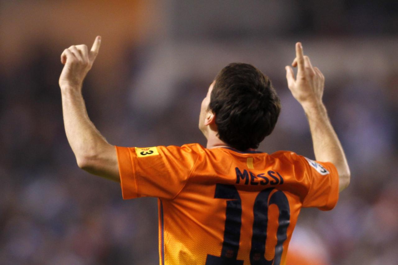'Barcelona\'s Lionel Messi celebrates his second goal against Deportivo Coruna during their Spanish First Division soccer match at the Riazor stadium in Coruna October 20, 2012. REUTERS/Miguel Vidal (
