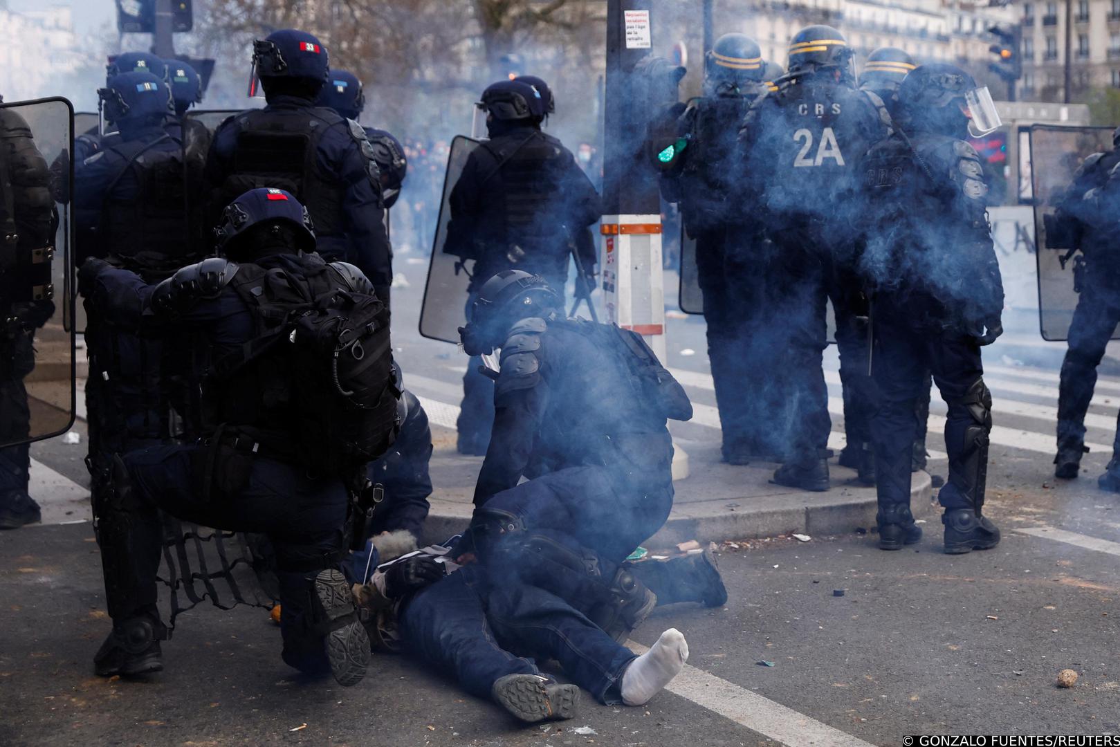 French riot police surround a protester lying on the ground during clashes at a demonstration as part of the tenth day of nationwide strikes and protests against French government's pension reform, in Paris, France, March 28, 2023. REUTERS/Gonzalo Fuentes Photo: GONZALO FUENTES/REUTERS