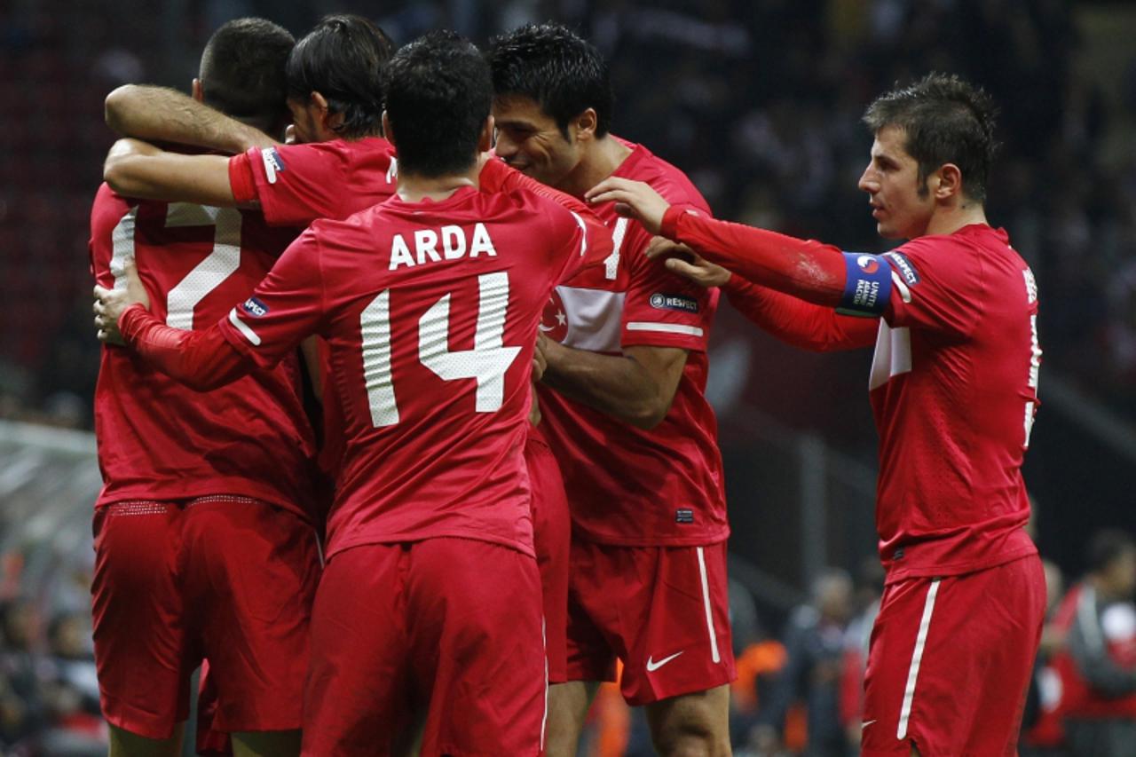 \'Turkey\'s Burak Yilmaz (L) celebrates with his team mates after scoring a goal against Azerbaijan during their Euro 2012 qualifying Group A soccer match at Turk Telekom Arena in Istanbul October 11,