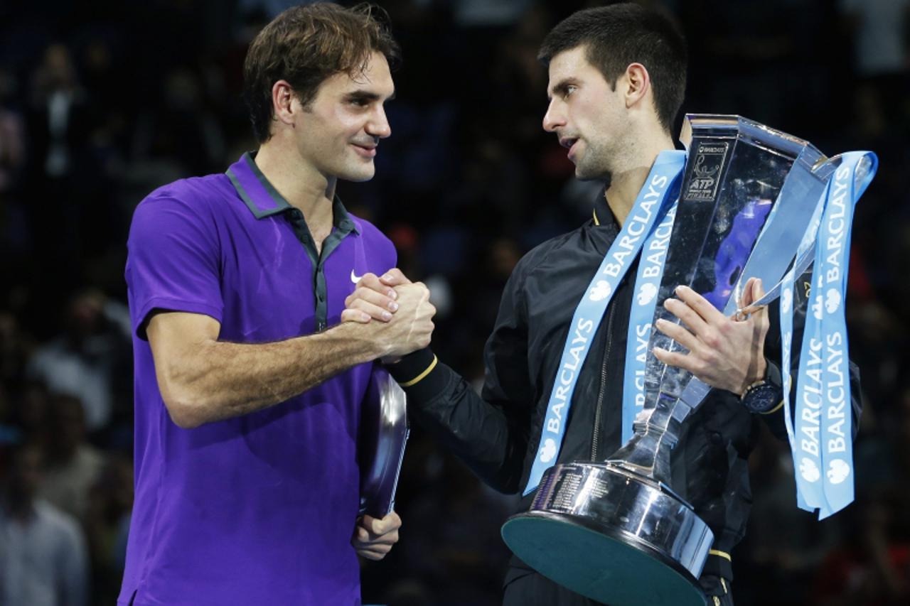 'Serbia\'s Novak Djokovic (R) shakes hands with Switzerland\'s Roger Federer after beating him in their final tennis match during the ATP World Tour Finals at the O2 Arena in London November 12, 2012.