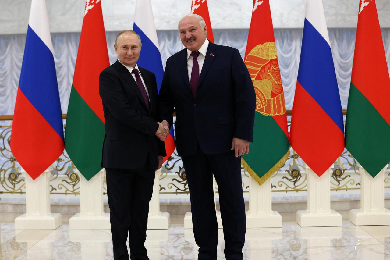 Russian President Vladimir Putin and Belarusian President Alexander Lukashenko shake hands before their meeting in Minsk
