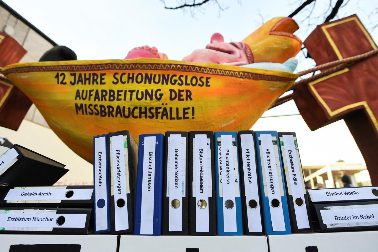 Mock folders with different labels concerning the abuse cases in the German Catholic Church are seen during a protest in front of the Catholic Academy in Munich