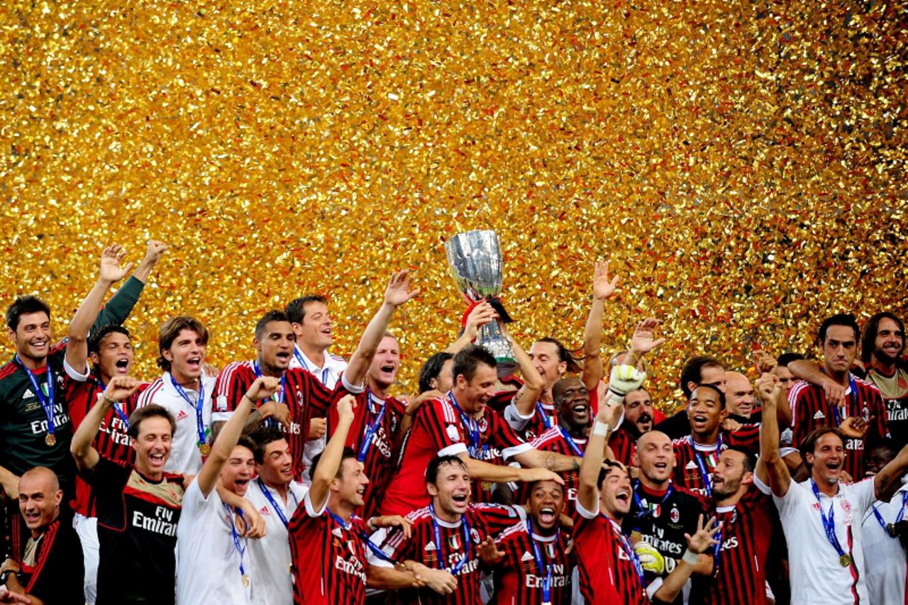 'Football team players of AC Milan celebrate with the trophy after winning the Italian Super Cup 2011 match against Inter Milan at China\'s National Stadium, known as Bird\'s Nest, in Beijing on Augus
