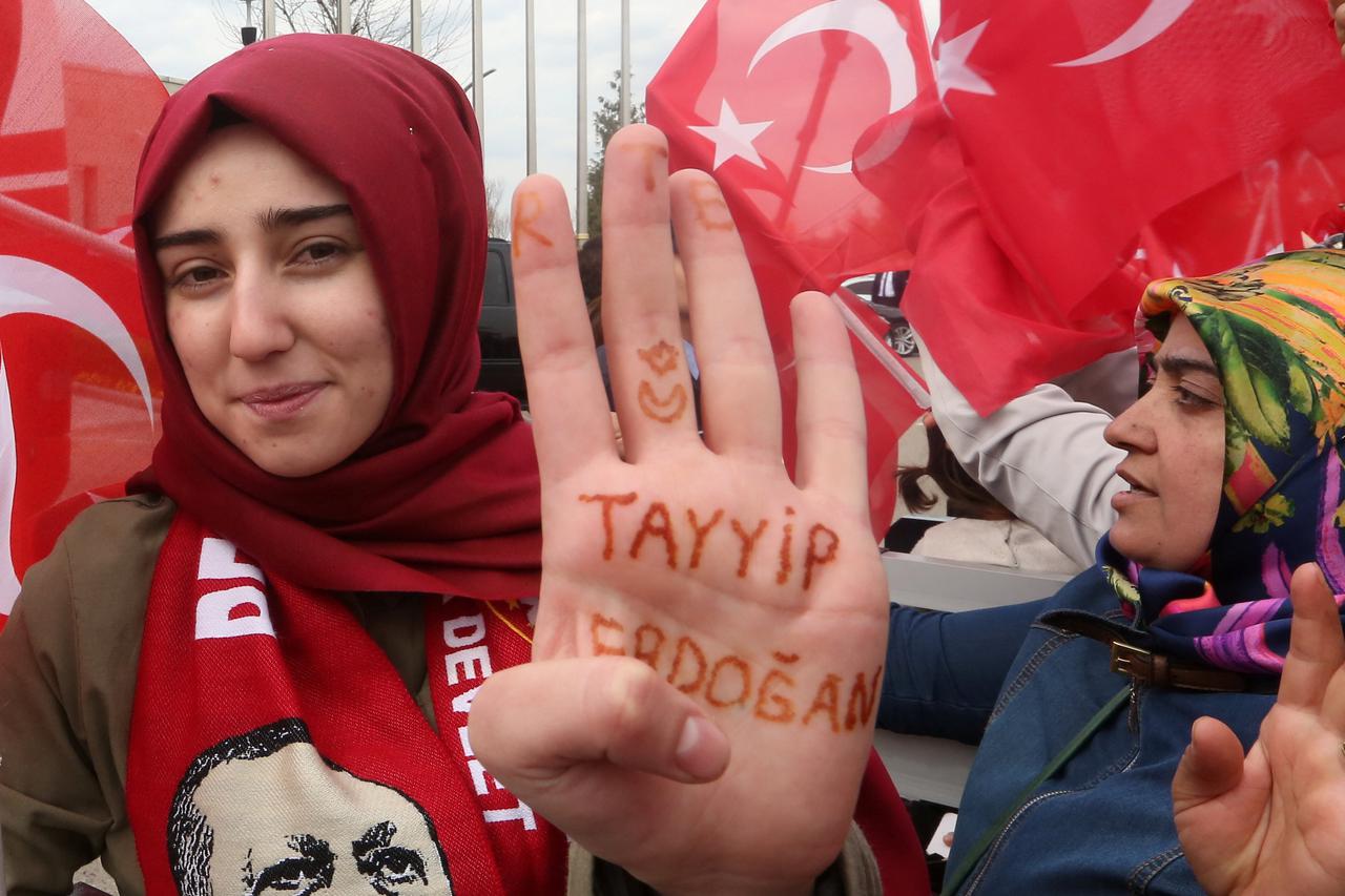 A woman shows her hand, which reads 