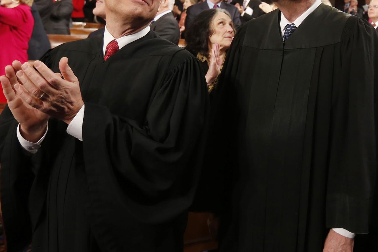 U.S. Supreme Court Chief Justice John Roberts (L) applauds with fellow Justice Anthony Kennedy  prior to President Barack Obama's State of the Union speech on Capitol Hill in Washington, in this January 28, 2014 file photo. The Supreme Court session that 
