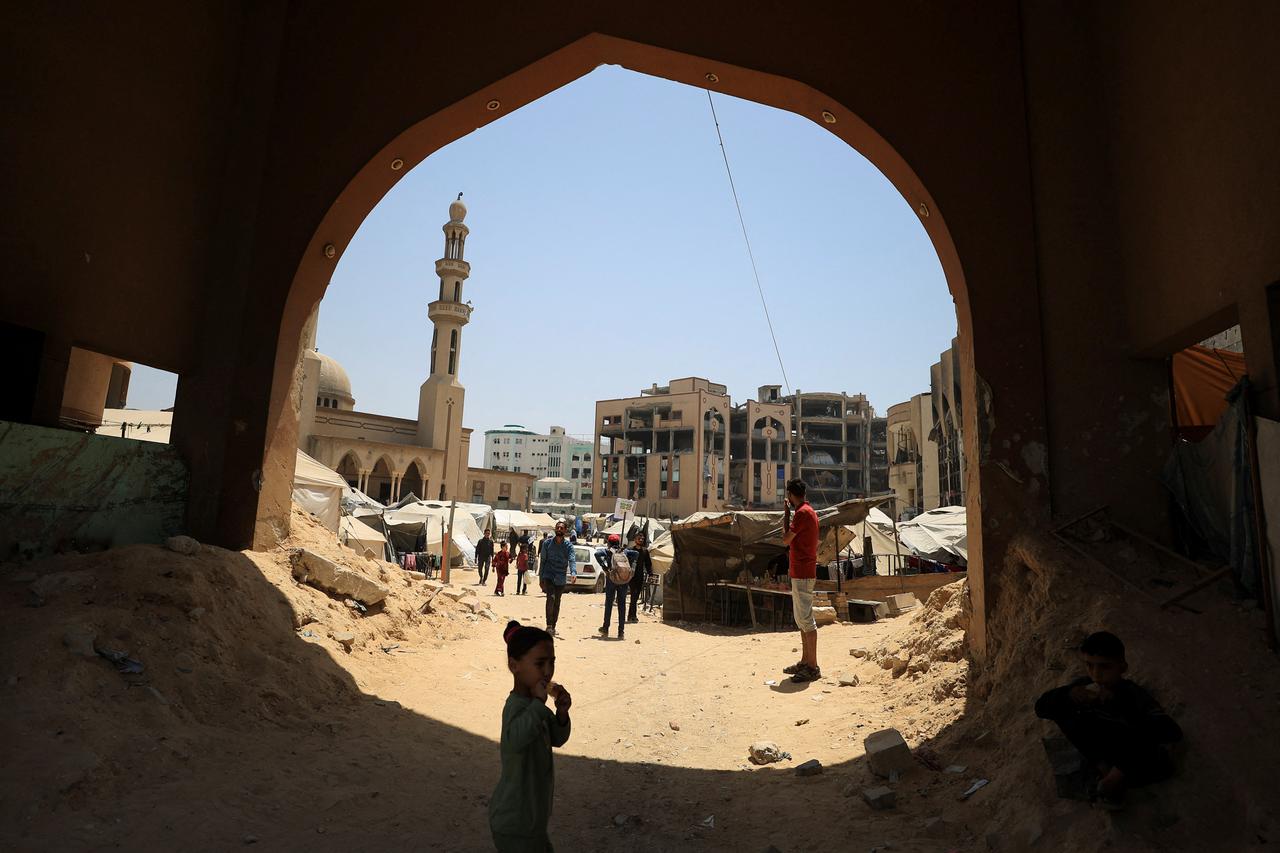 Palestinians, displaced by the Israeli offensive, shelter inside the destroyed Islamic University of Gaza, in Gaza City