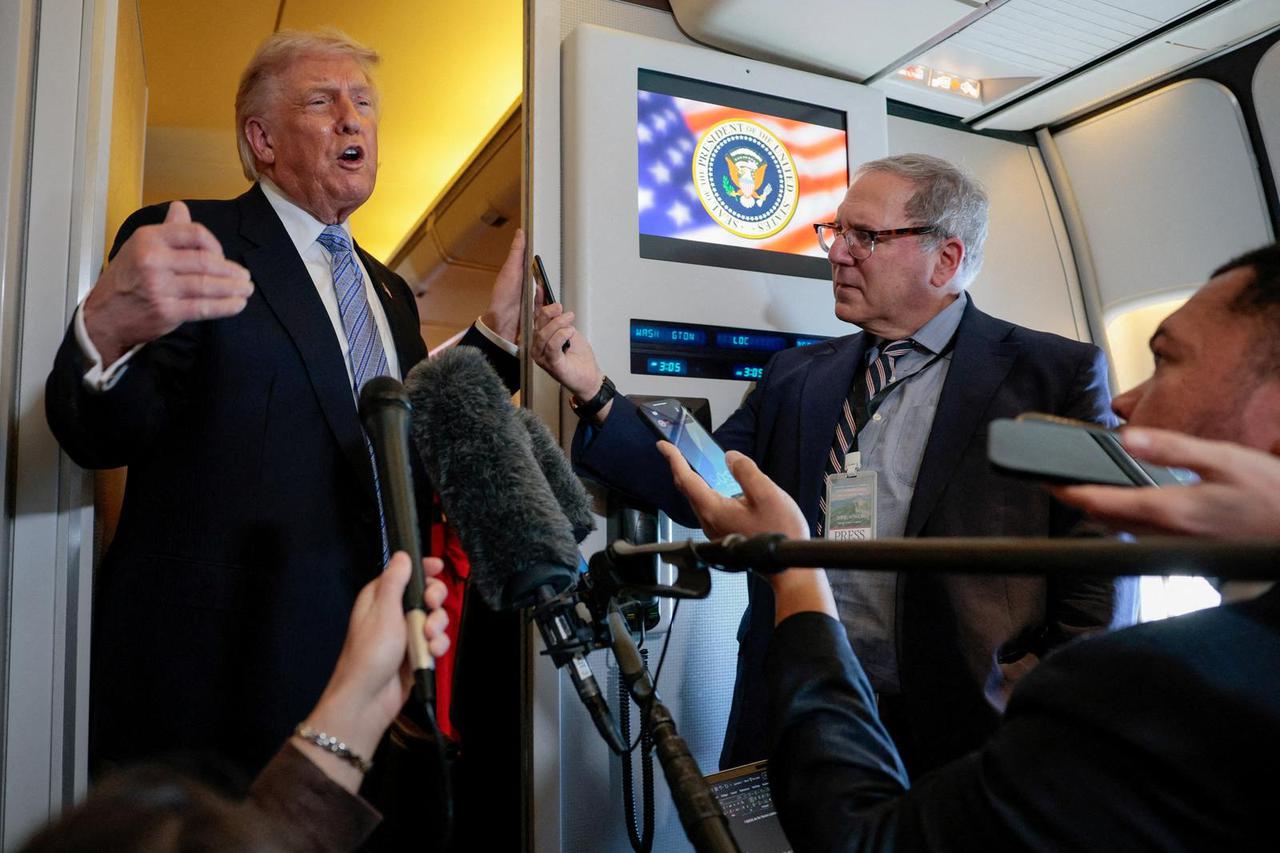 U.S. President Donald Trump speaks to members of the media on board Air Force One, following his visit to China