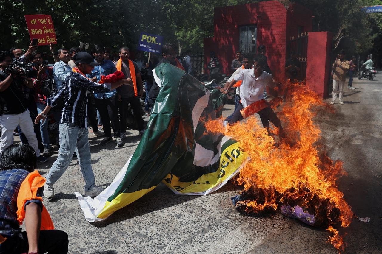 Activists from Vishwa Hindu Parishad (VHP) and Bajrang Dal burn an effigy of terrorism and burn the Pakistan national flag during a protest against the killing of tourists by militants near Pahalgam, in Ahmedabad