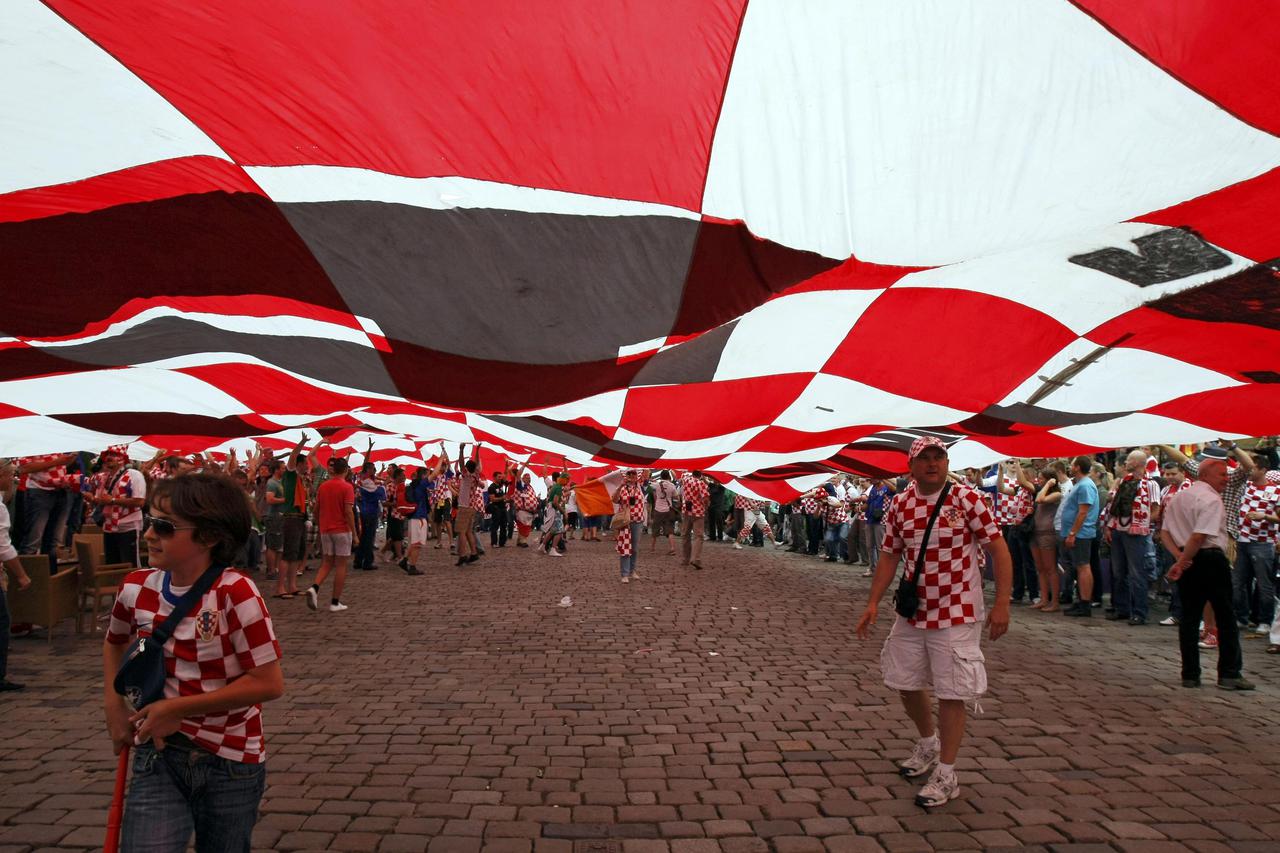 Croatian supporters walk under a large flag before the Euro 2012 soccer match between Croatia and Ireland in Poznan June 10, 2012.  REUTERS/Kacper Pempel (POLAND  - Tags: SPORT SOCCER)  Picture Supplied by Action Images