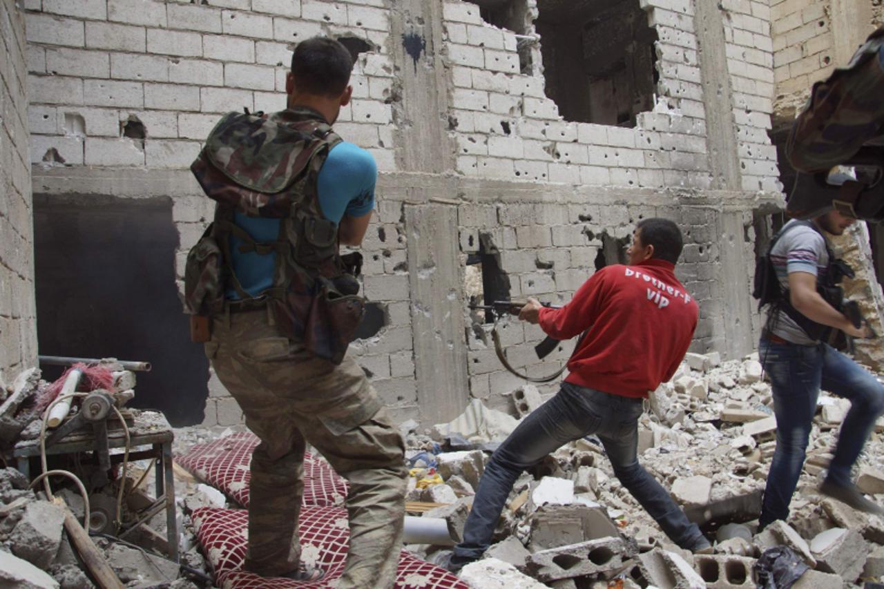 'Free Syrian Army fighters return fire after what they say was during clashes with forces loyal to President Bashar al-Assad in Deir al-Zor May 13, 2013. Picture taken May 13, 2013. REUTERS/Khalil Ash