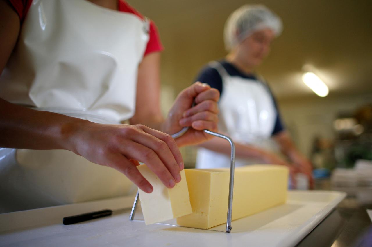 FILE PHOTO: An employee prepares organic unpasteurised butter at a milk farm in Saint-Colomban