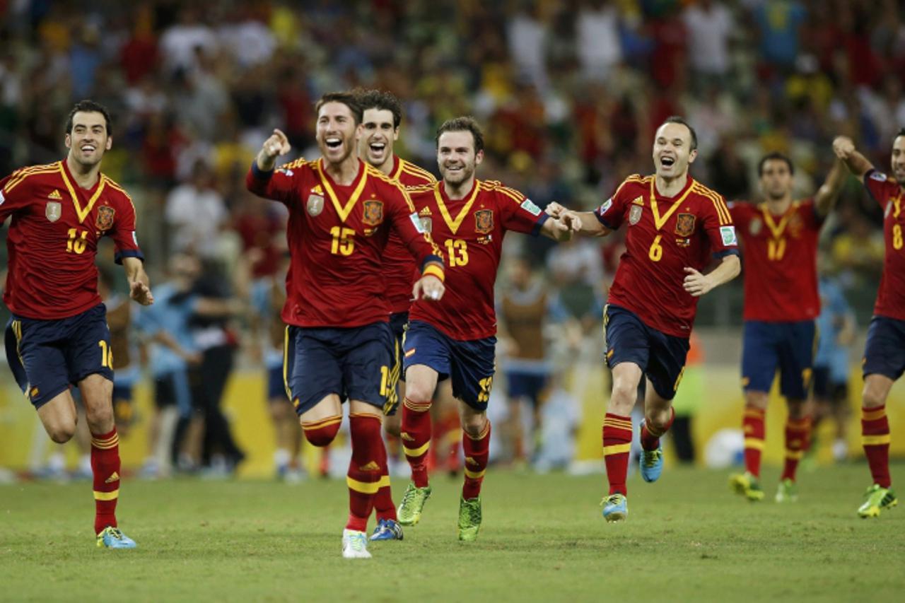 'Spain's players celebrate after their teammate Jesus Navas scored the winning penalty goal against Italy's goalkeeper Gianluigi Buffon during the penalty shootout of their Confederations Cup semi-f