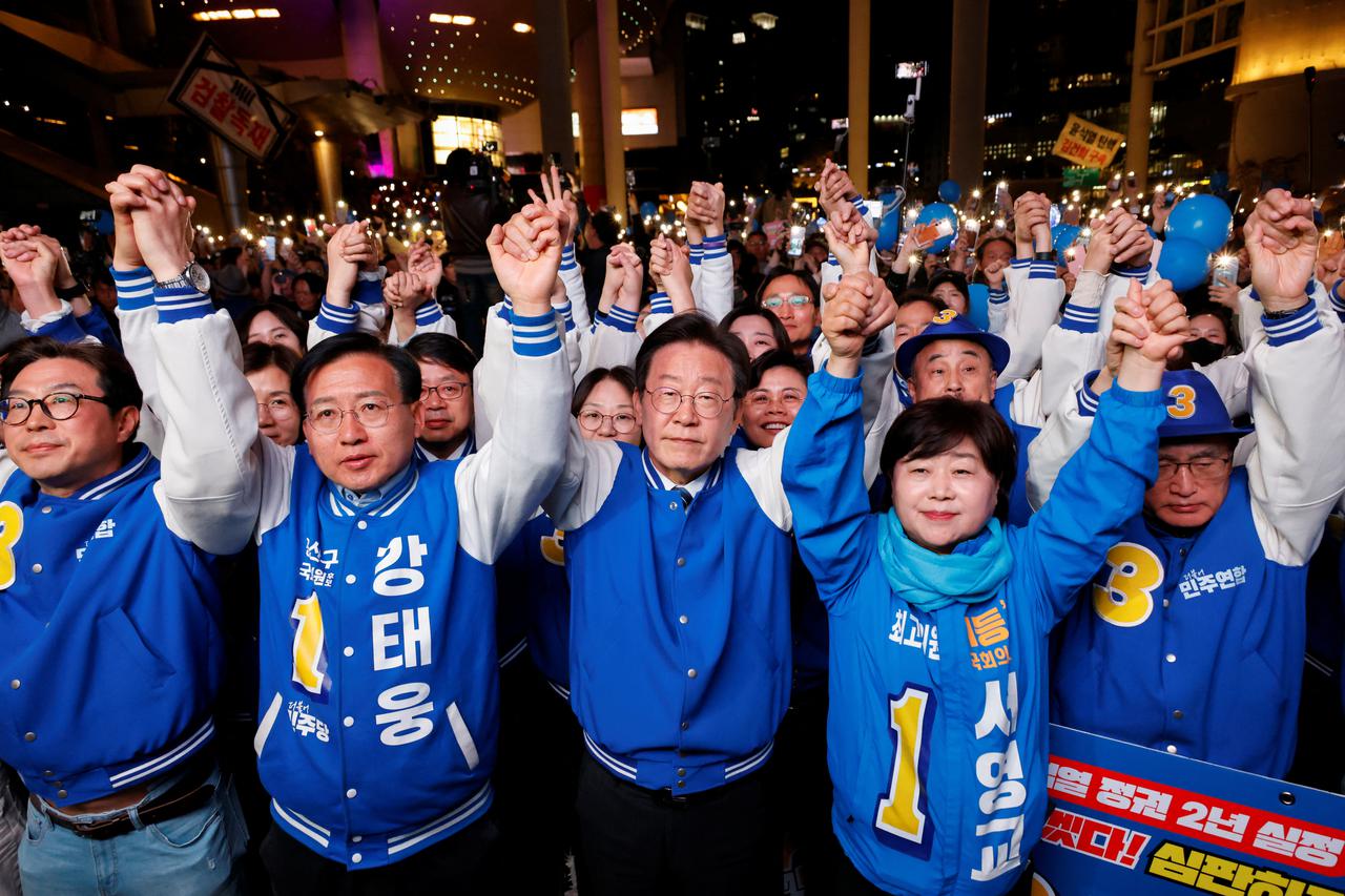 Lee Jae-myung, leader of the main opposition Democratic Party, raises hands with supporters during a campaign rally for the upcoming 22nd parliamentary election in Seoul